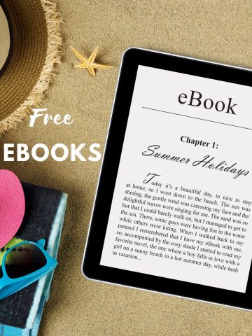 Tablet with an eBook on a sandy background with flip flops, hat, sunglasses, beach wear.